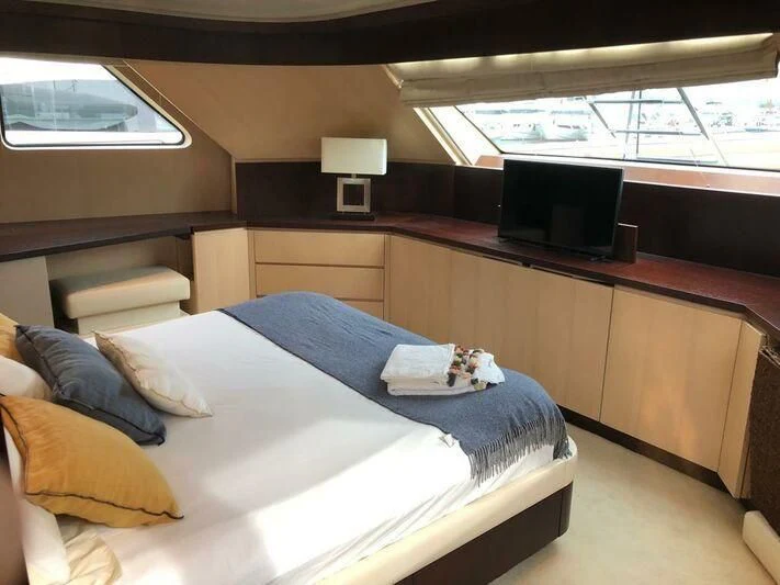 a room with a bed and a television aboard AKUA Yacht for Sale