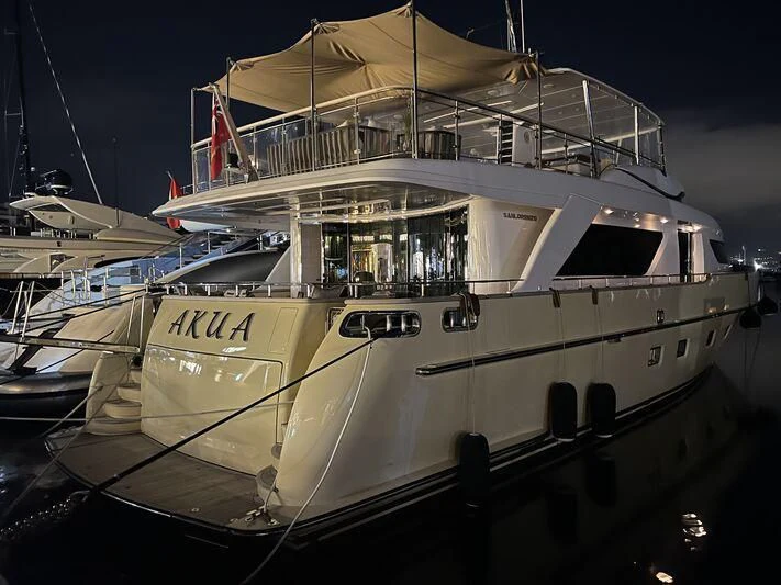 a boat docked at night aboard AKUA Yacht for Sale