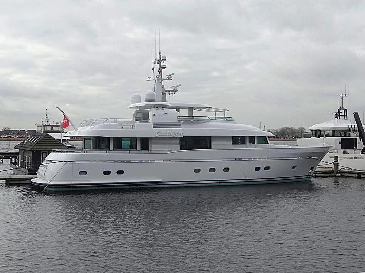 a large white boat in a harbor aboard BELLE DE JOUR Yacht for Sale