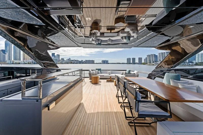 a wooden deck with a view of a city and water aboard BESO Yacht for Sale