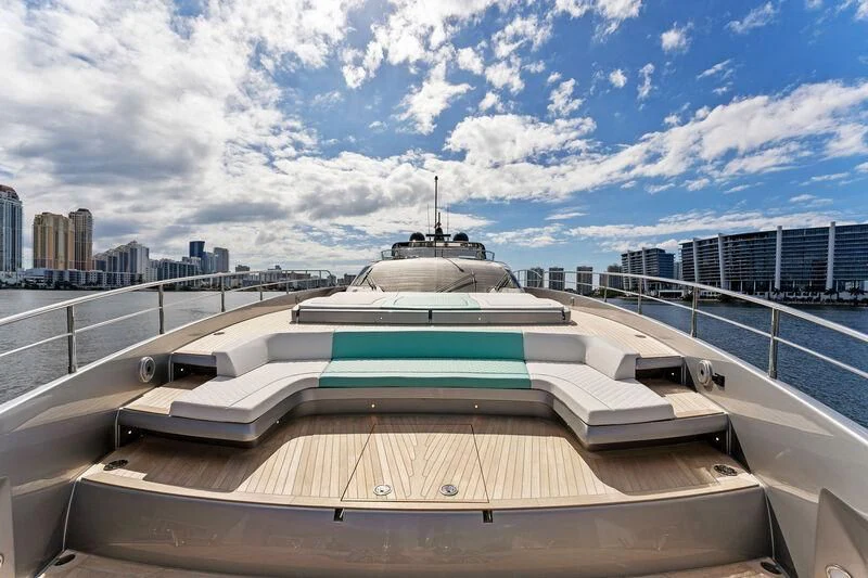 a large white building with a large glass roof and a city in the background aboard BESO Yacht for Sale