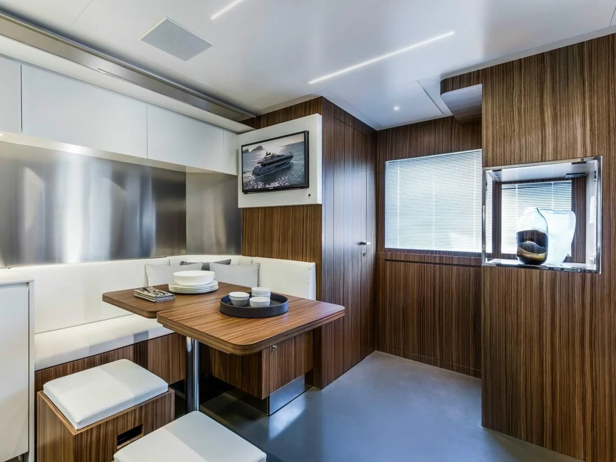 a room with a table and chairs aboard BESO Yacht for Sale