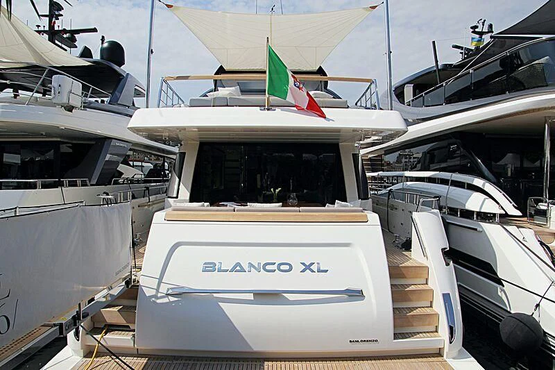 a boat with a flag on the front aboard BLANCO XL Yacht for Sale