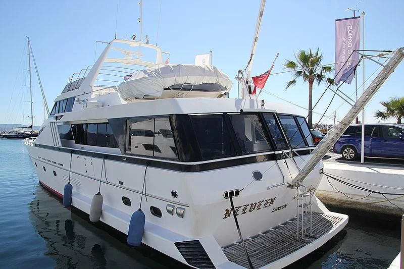 a white boat in a harbor aboard NEEVEEN Yacht for Sale