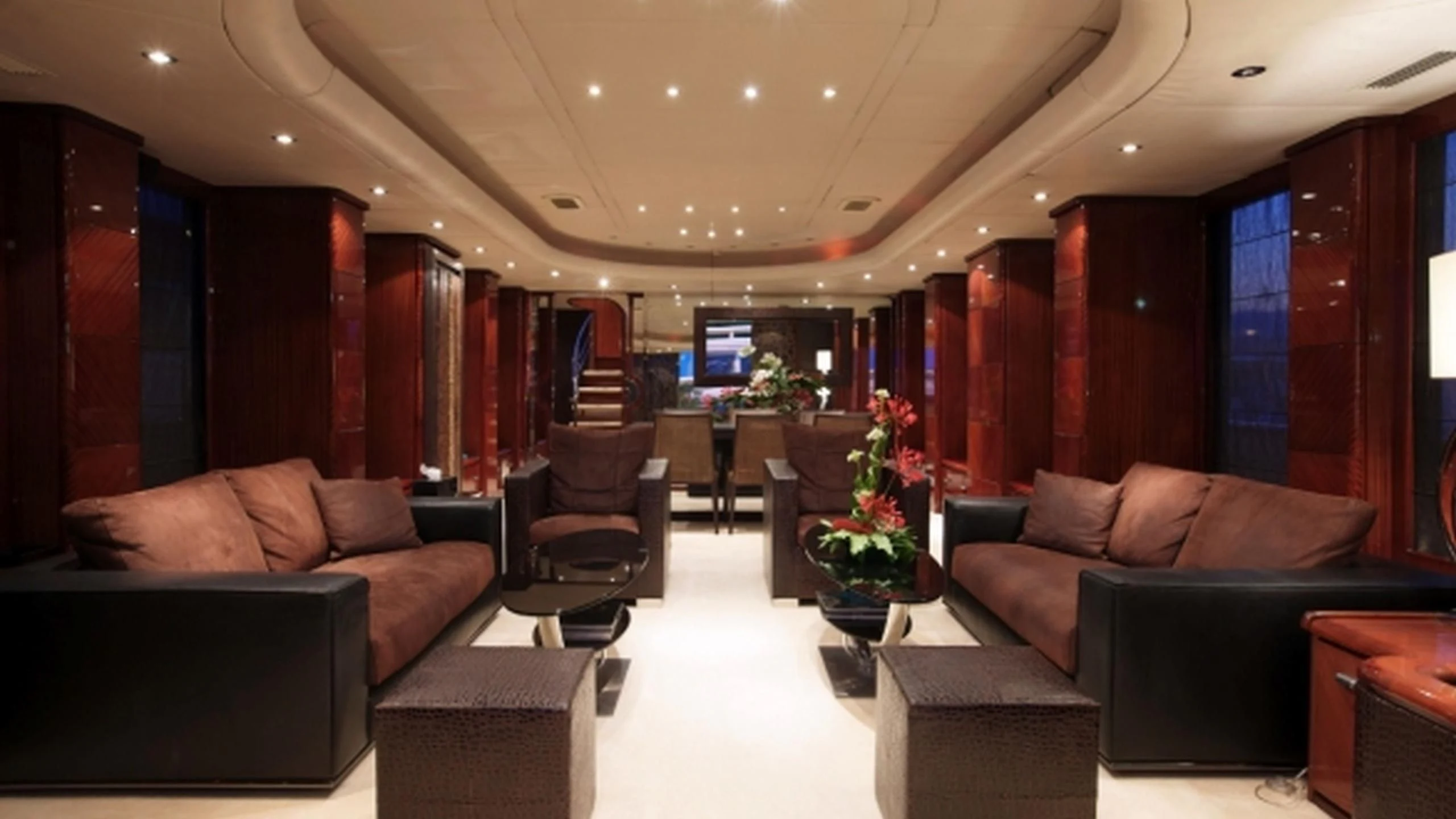 a living room with leather couches aboard L'OR Yacht for Sale