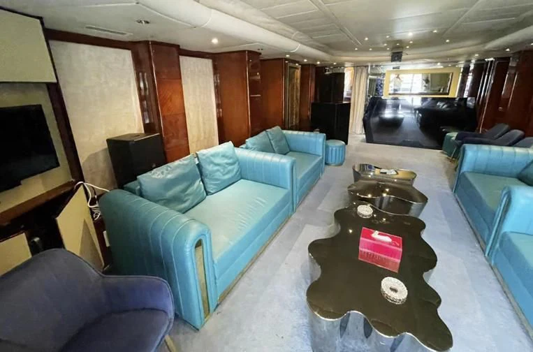 a living room with a couch and a television aboard L'OR Yacht for Sale