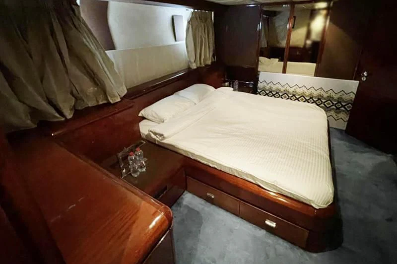 a bed in a room aboard L'OR Yacht for Sale