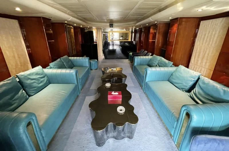 a living room with a couch and a table aboard L'OR Yacht for Sale