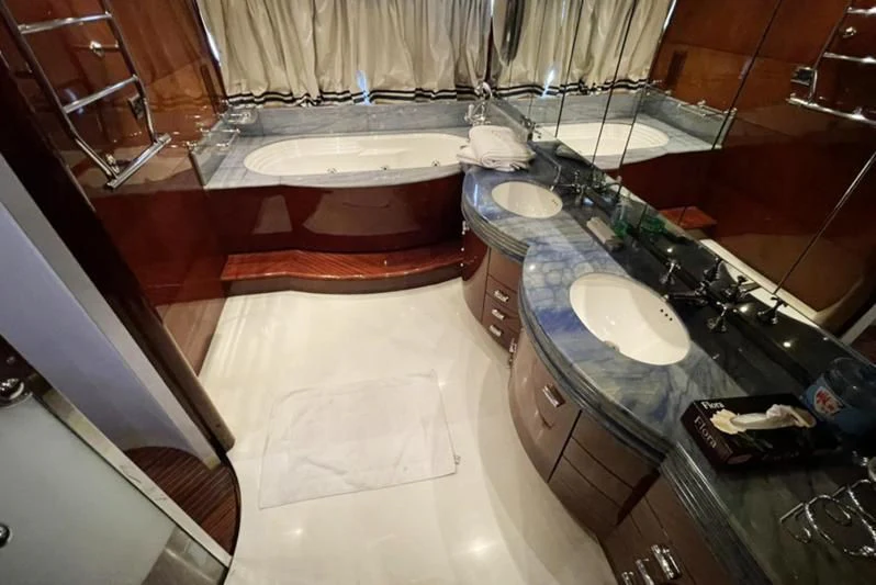 a bathroom with a tub sink and a sink aboard L'OR Yacht for Sale