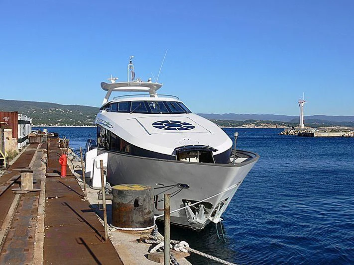 a boat docked at a pier aboard L'OR Yacht for Sale