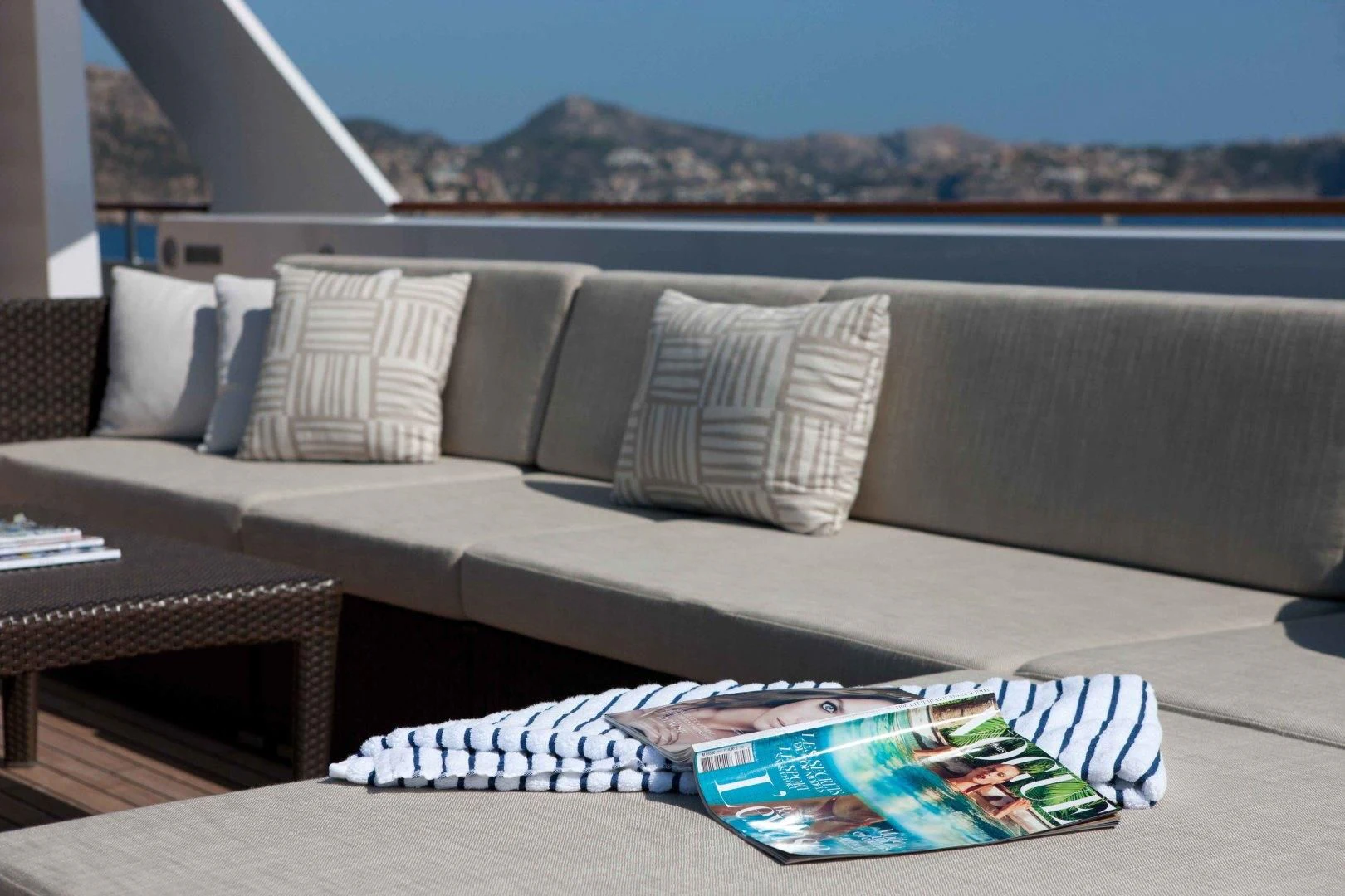 a couch with pillows and a table aboard MIRAGE Yacht for Sale