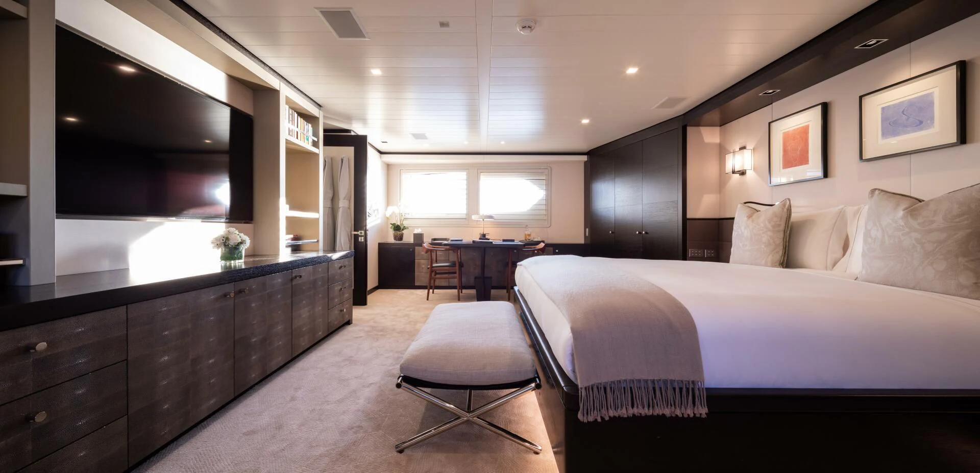 a large bedroom with a bed and desk aboard MIRAGE Yacht for Sale