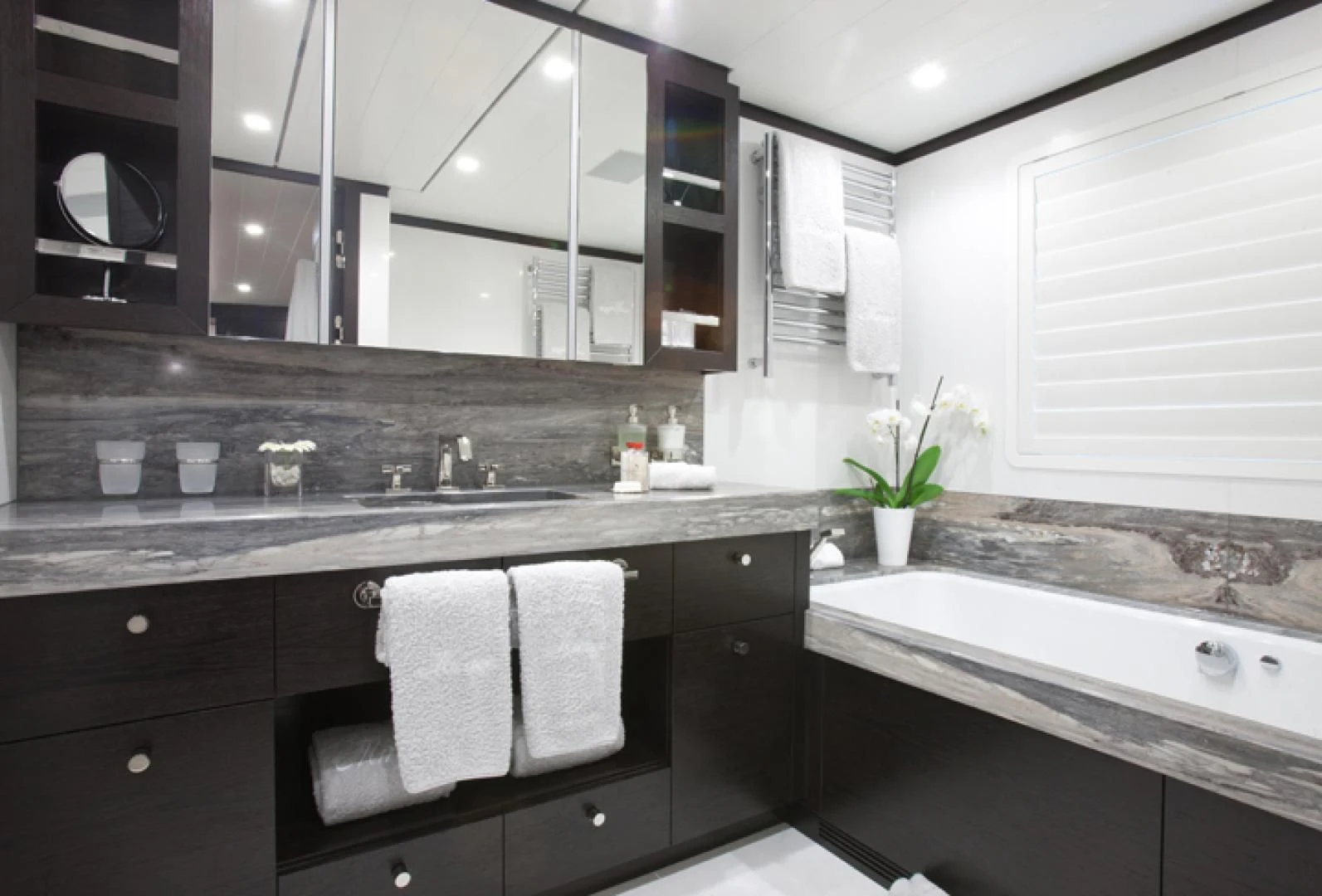 a kitchen with black cabinets aboard MIRAGE Yacht for Sale