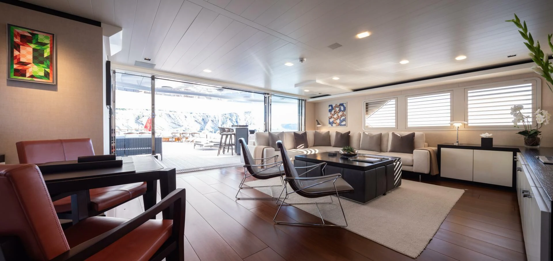 a large room with a table and chairs aboard MIRAGE Yacht for Sale