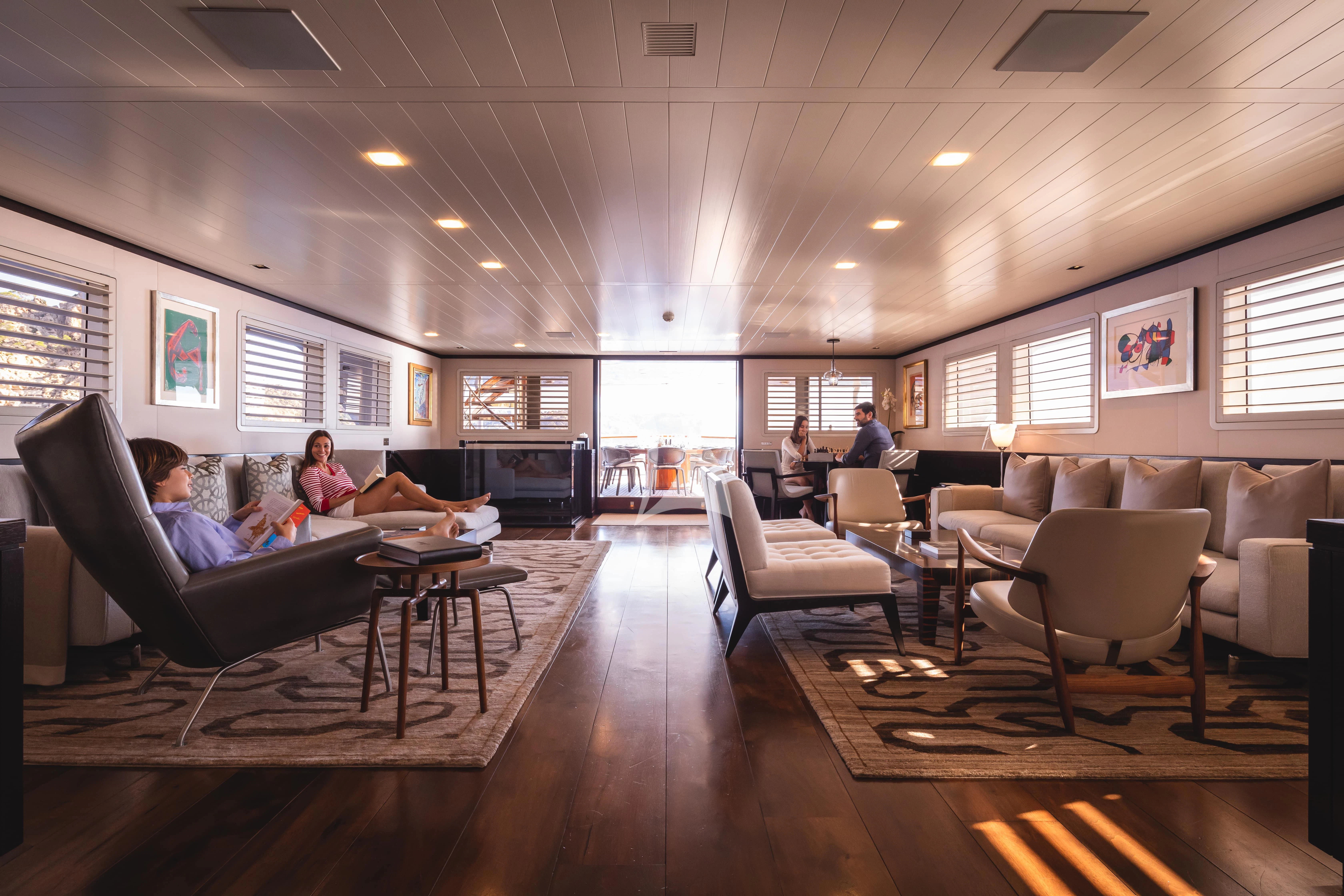 a living room with a large window aboard MIRAGE Yacht for Sale