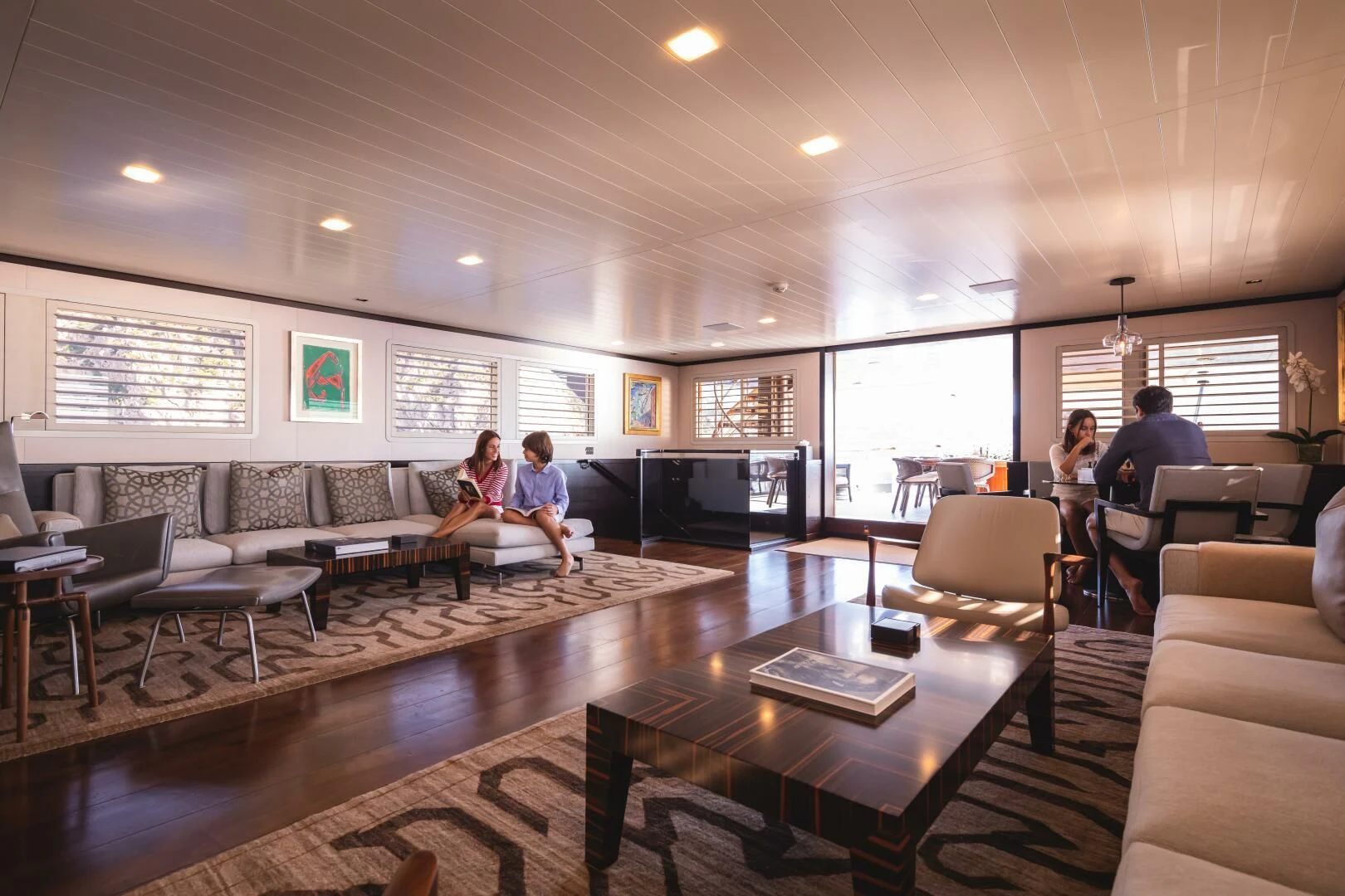 people sitting in a room aboard MIRAGE Yacht for Sale
