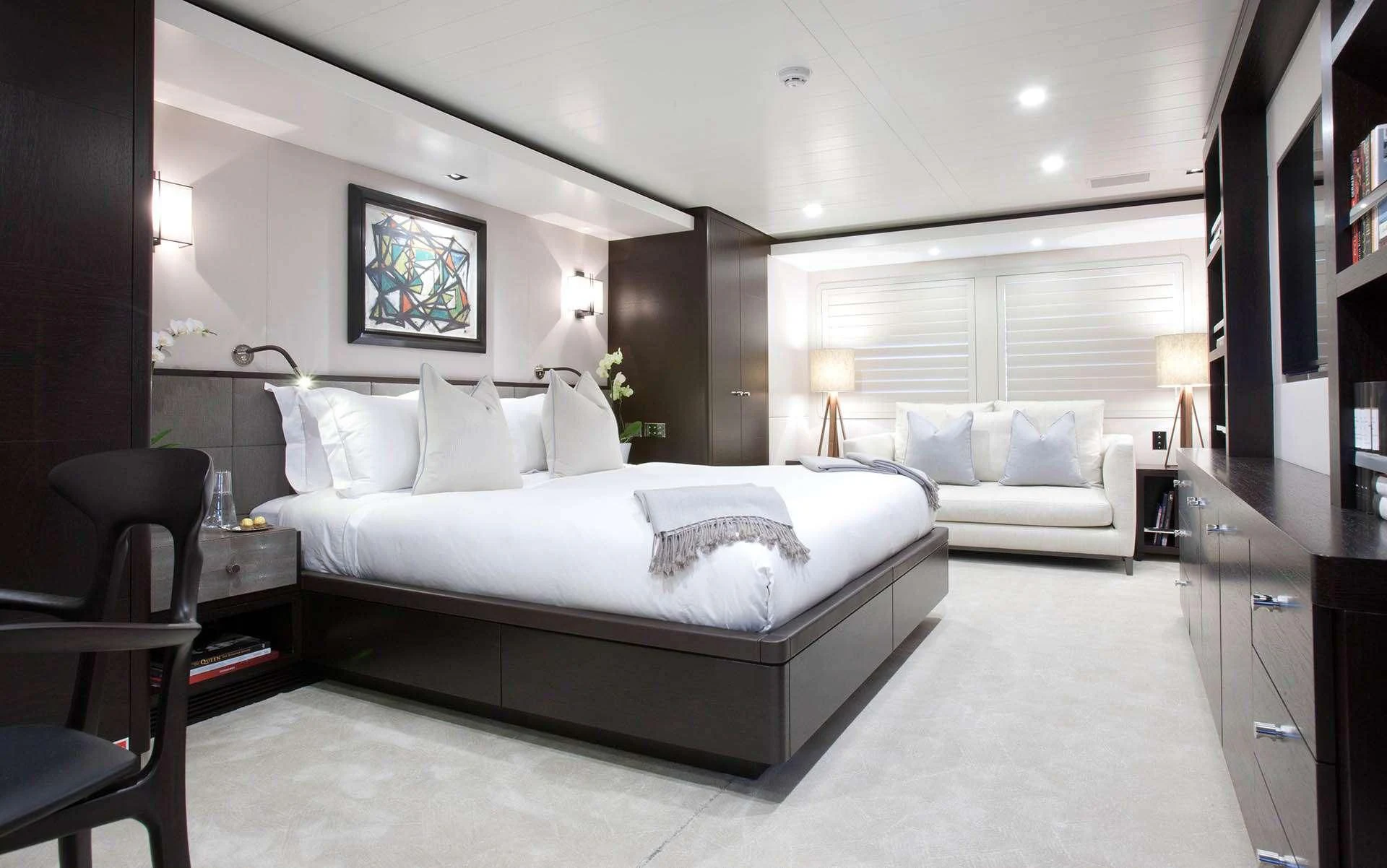 a large bedroom with a bed and a couch aboard MIRAGE Yacht for Sale
