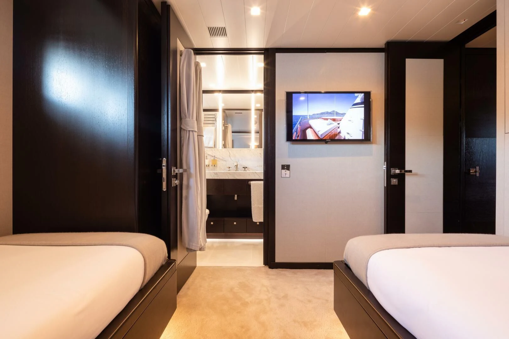 a room with a tv and a bed aboard MIRAGE Yacht for Sale