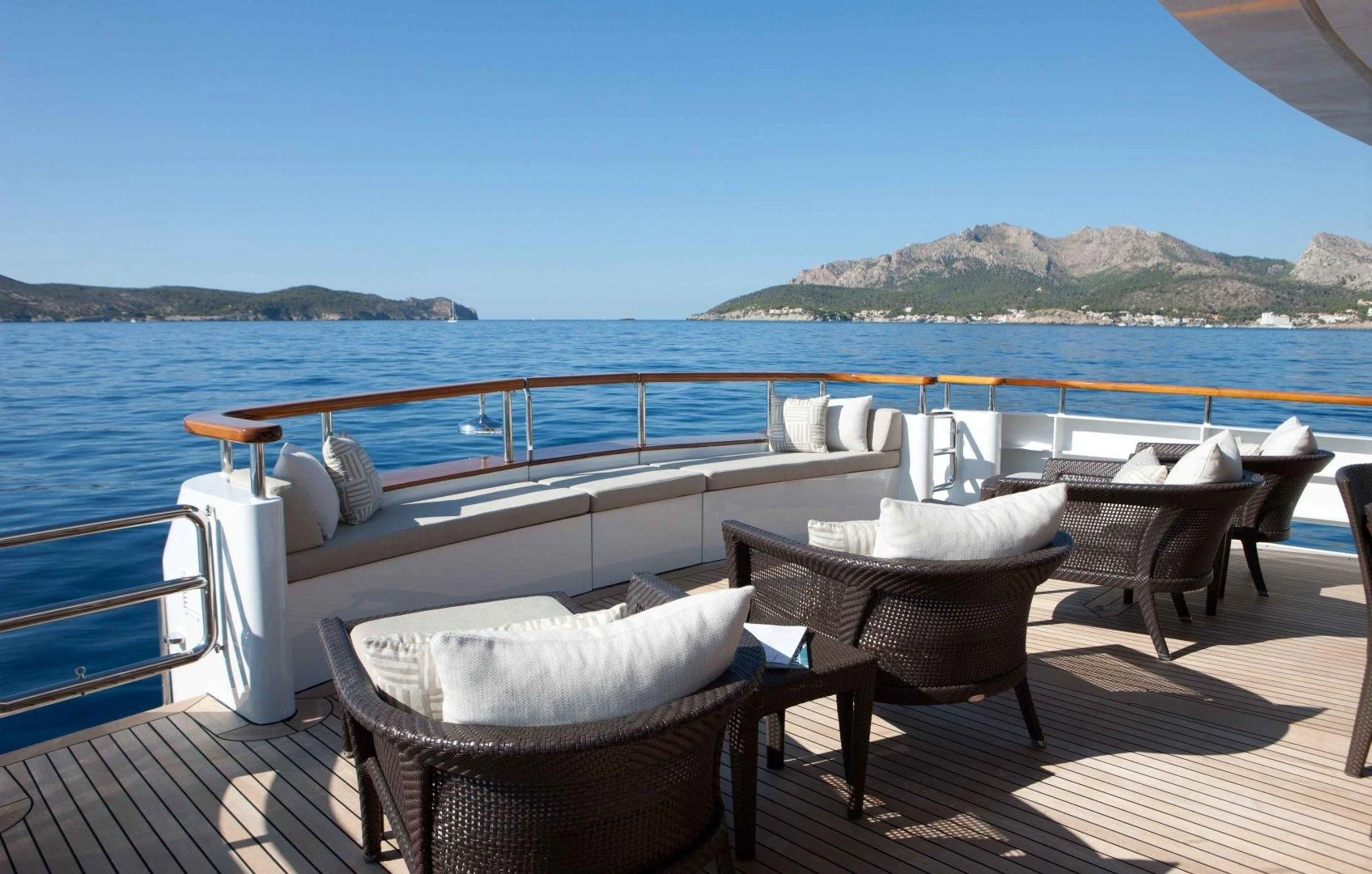 a table and chairs on a deck overlooking a large body of water aboard MIRAGE Yacht for Sale
