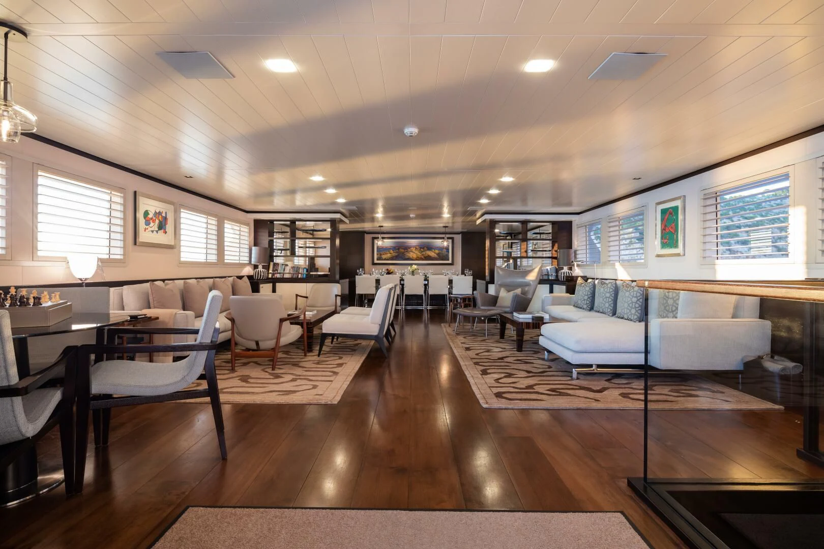 a living room with a wood floor aboard MIRAGE Yacht for Sale