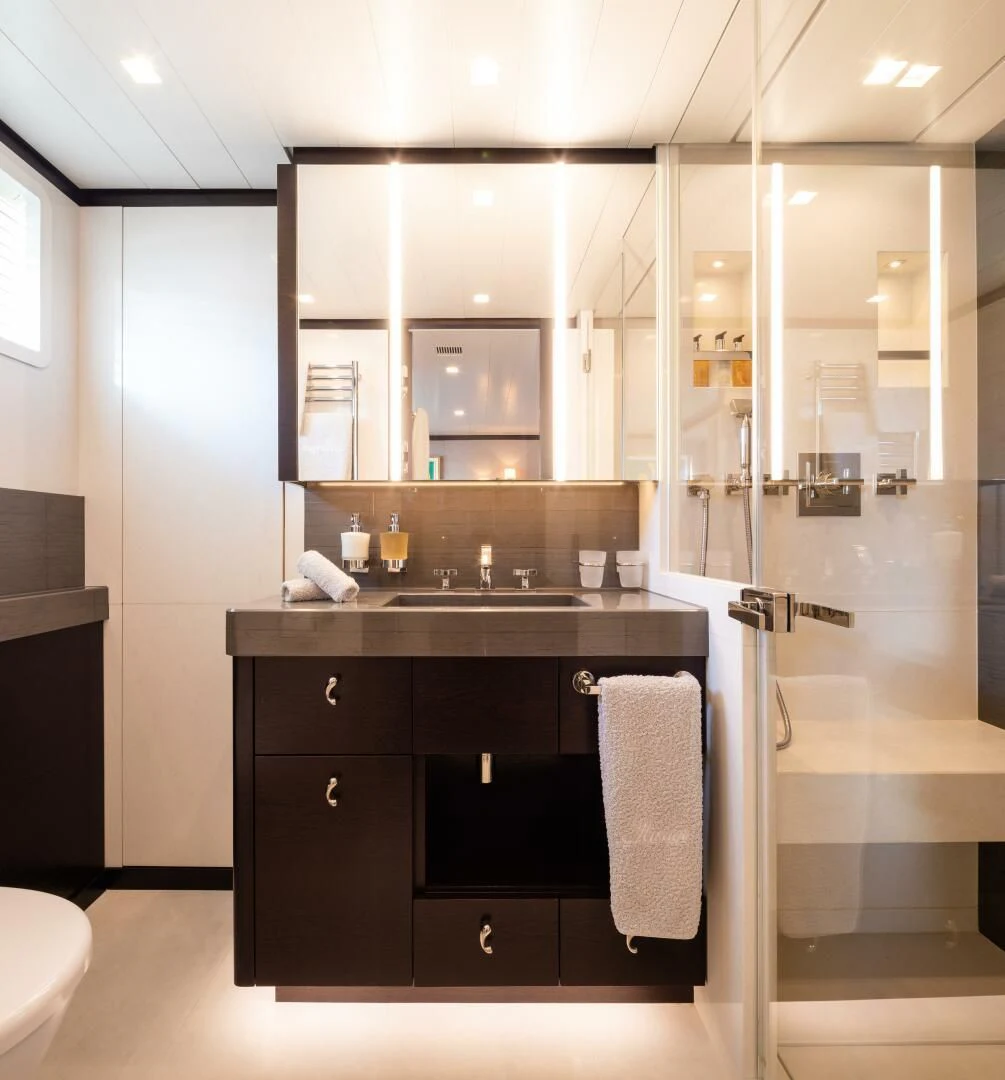 a bathroom with a glass shower aboard MIRAGE Yacht for Sale