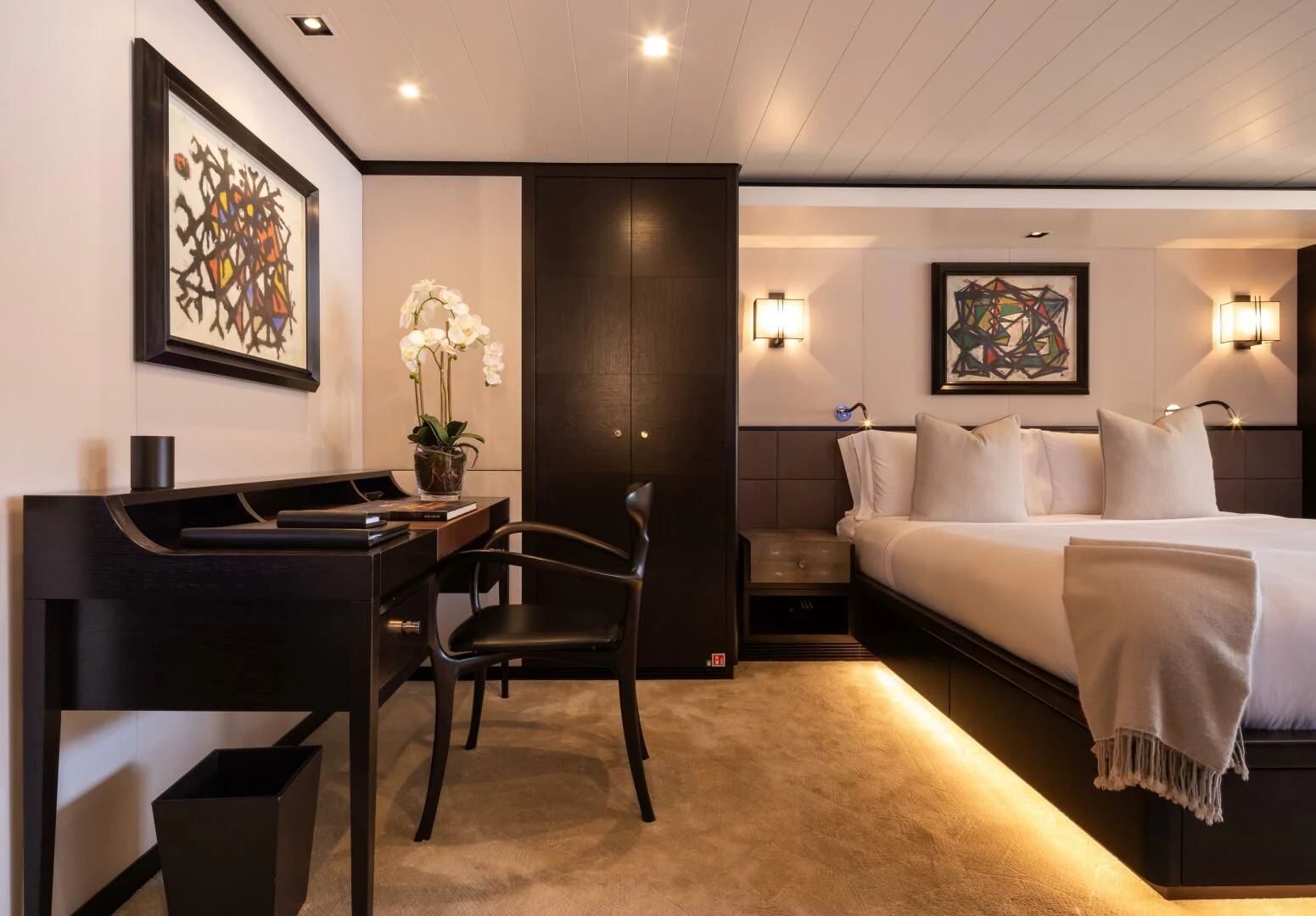 a hotel room with a bed and desk aboard MIRAGE Yacht for Sale