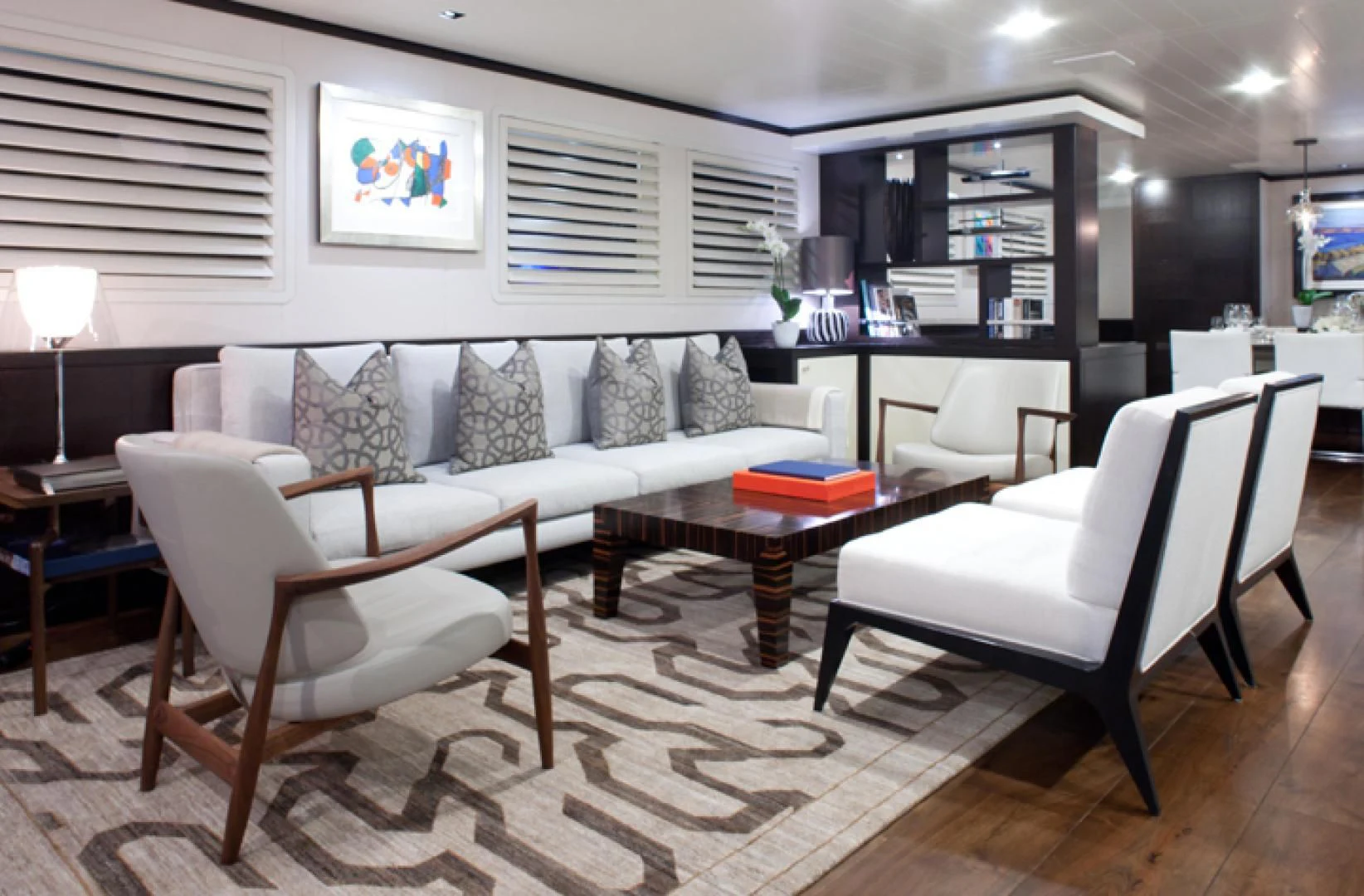 a living room with white furniture aboard MIRAGE Yacht for Sale
