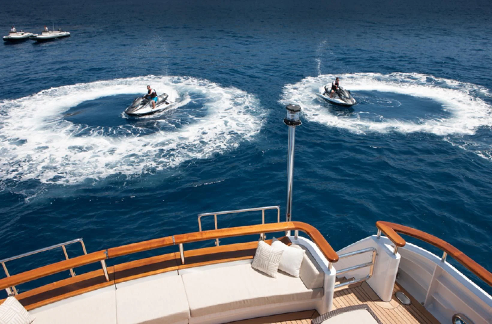 a couple of people riding surfboards aboard MIRAGE Yacht for Sale