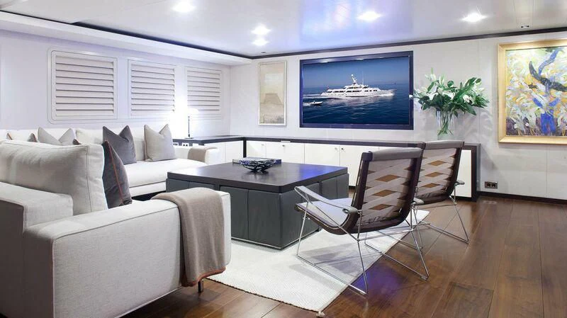 a room with a table and chairs aboard MIRAGE Yacht for Sale