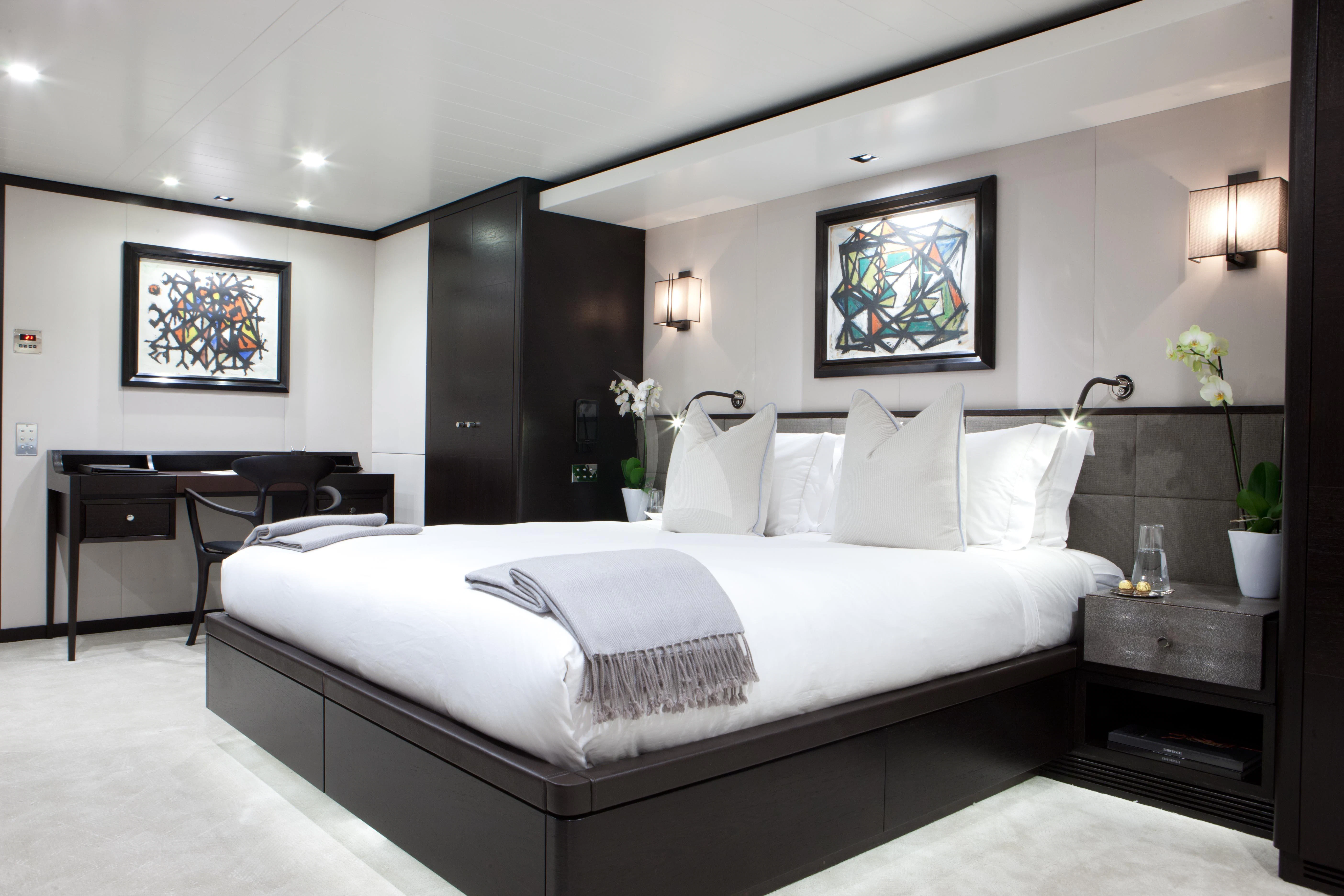 a bed with white sheets aboard MIRAGE Yacht for Sale
