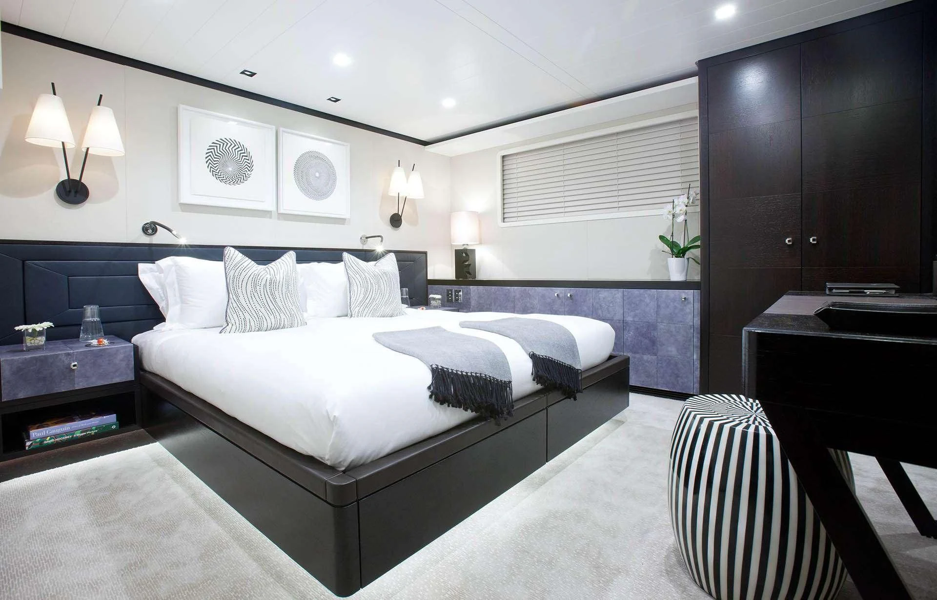 a bedroom with a large bed aboard MIRAGE Yacht for Sale