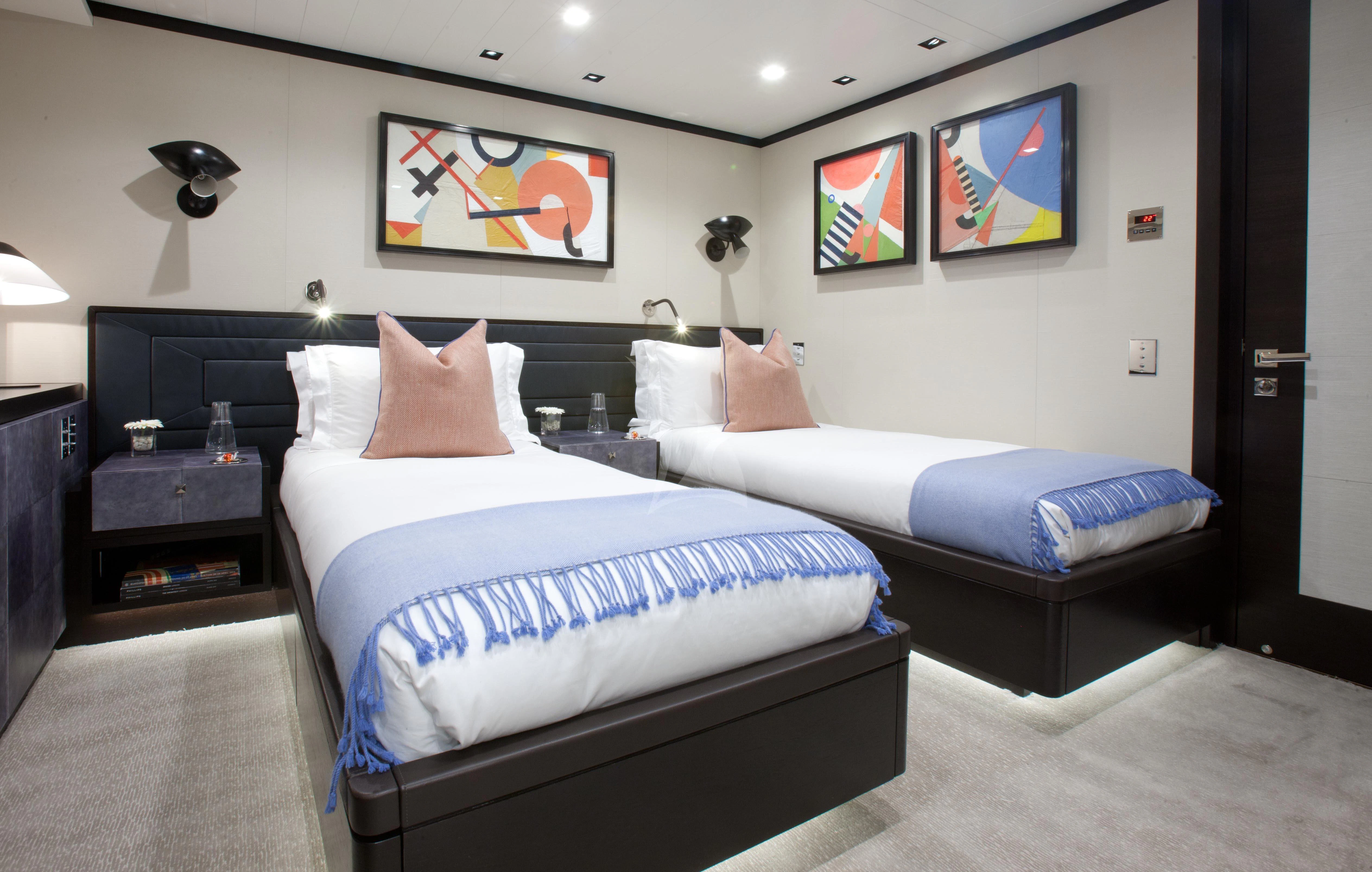 a room with two beds aboard MIRAGE Yacht for Sale