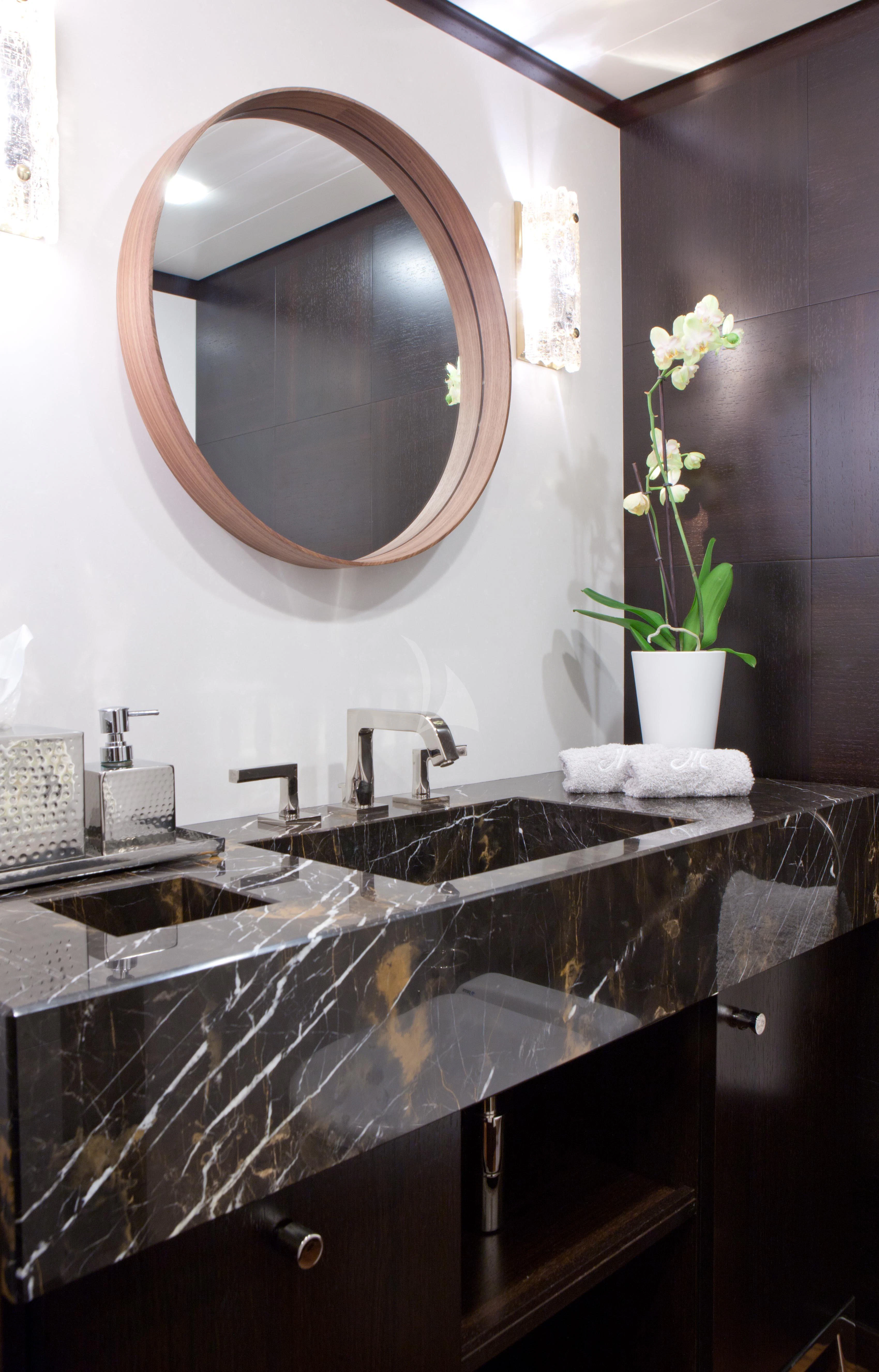 a bathroom with a large round mirror aboard MIRAGE Yacht for Sale