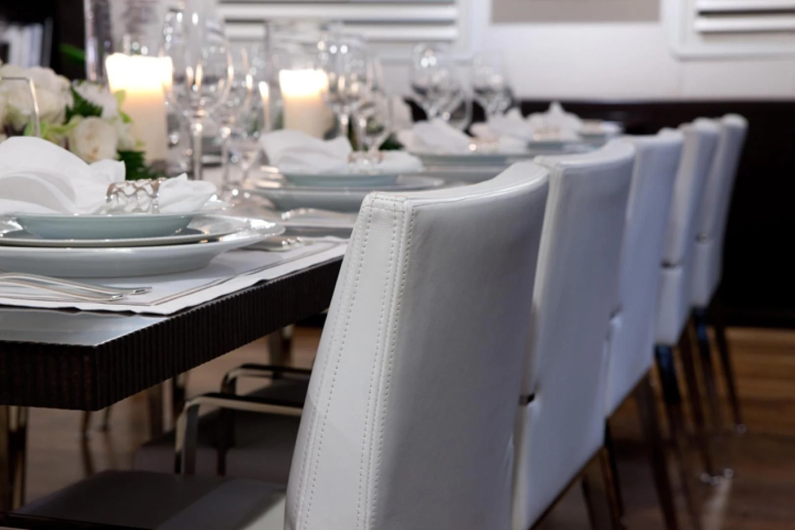 a table set with plates and glasses aboard MIRAGE Yacht for Sale