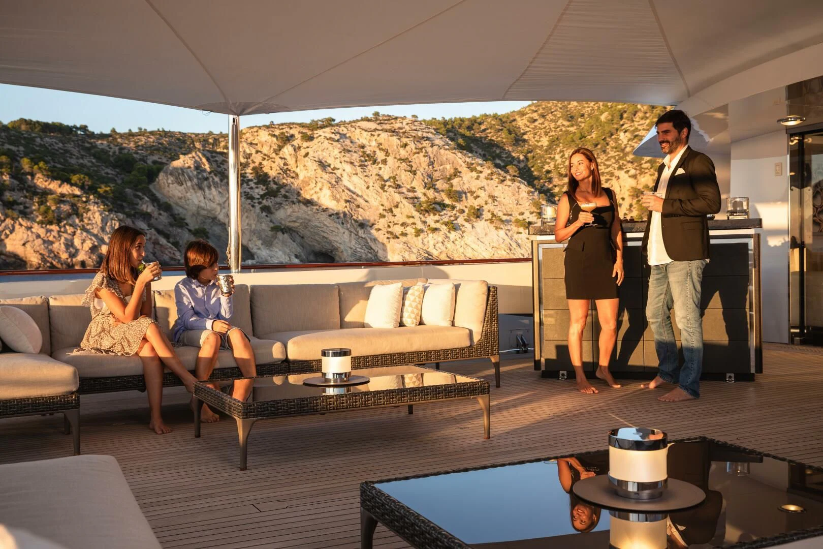 a group of people standing in a living room aboard MIRAGE Yacht for Sale