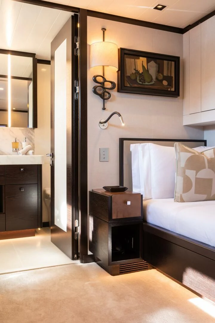 a bedroom with a bed and a mirror aboard MIRAGE Yacht for Sale