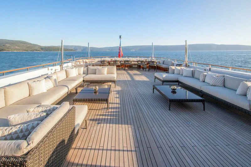 a deck with a view of the ocean and a large ship in the distance aboard MIRAGE Yacht for Sale