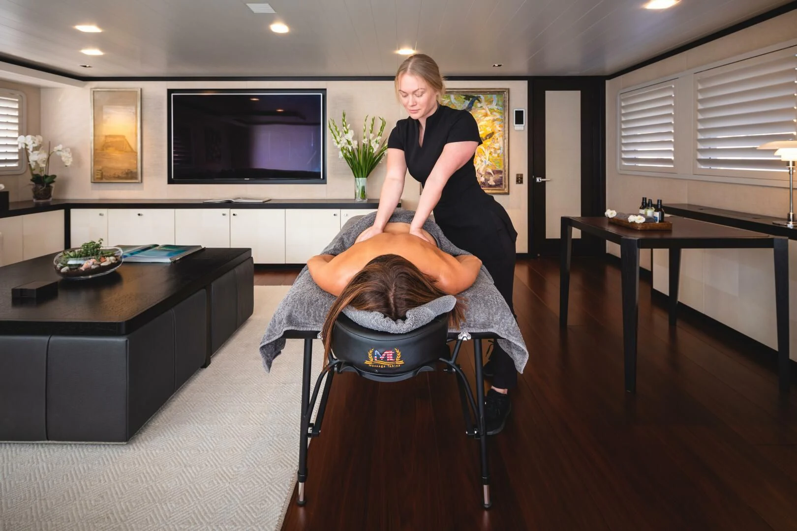 a person sitting on a chair aboard MIRAGE Yacht for Sale
