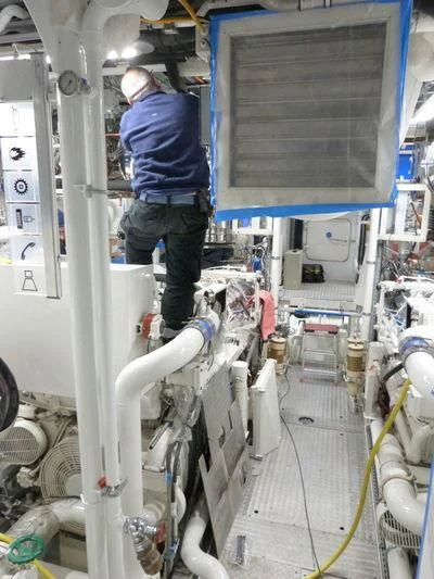 a person working on a machine aboard MIRAGE Yacht for Sale