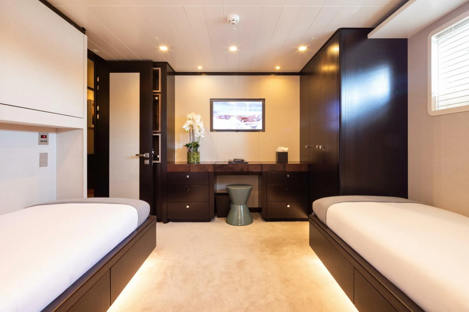 a bedroom with a bed and a desk aboard MIRAGE Yacht for Sale