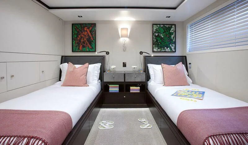 a room with two beds aboard MIRAGE Yacht for Sale
