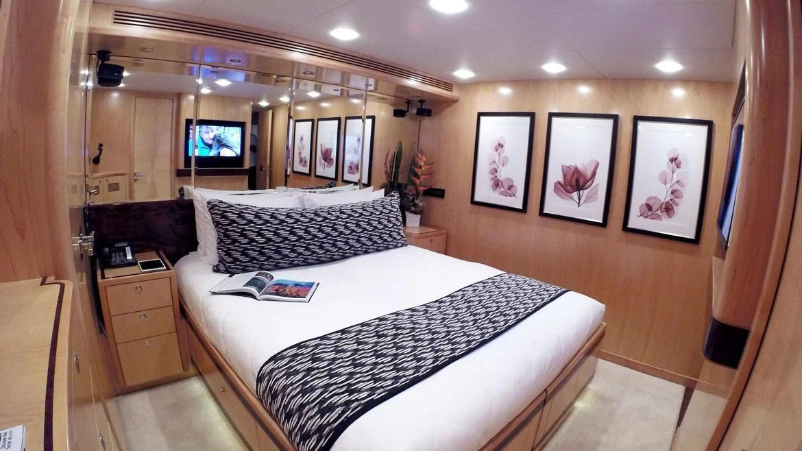 a hotel room with a bed and a television aboard SALVATORE II Yacht for Sale