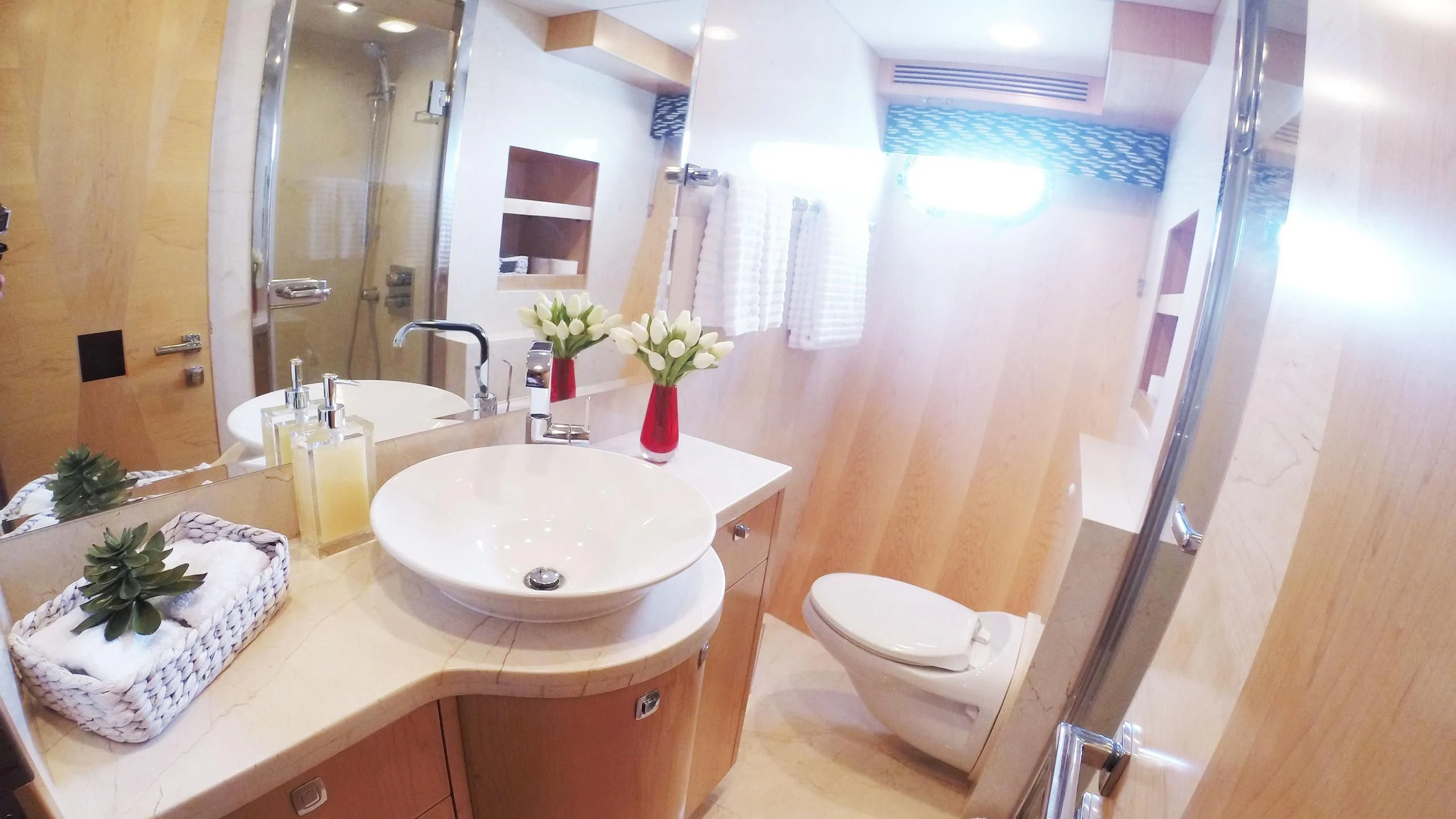 a bathroom with a sink toilet and a mirror aboard SALVATORE II Yacht for Sale