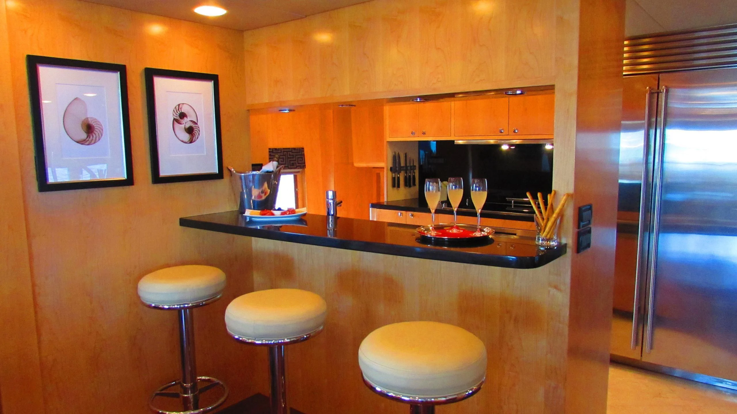 a bar with a countertop and stools aboard SALVATORE II Yacht for Sale