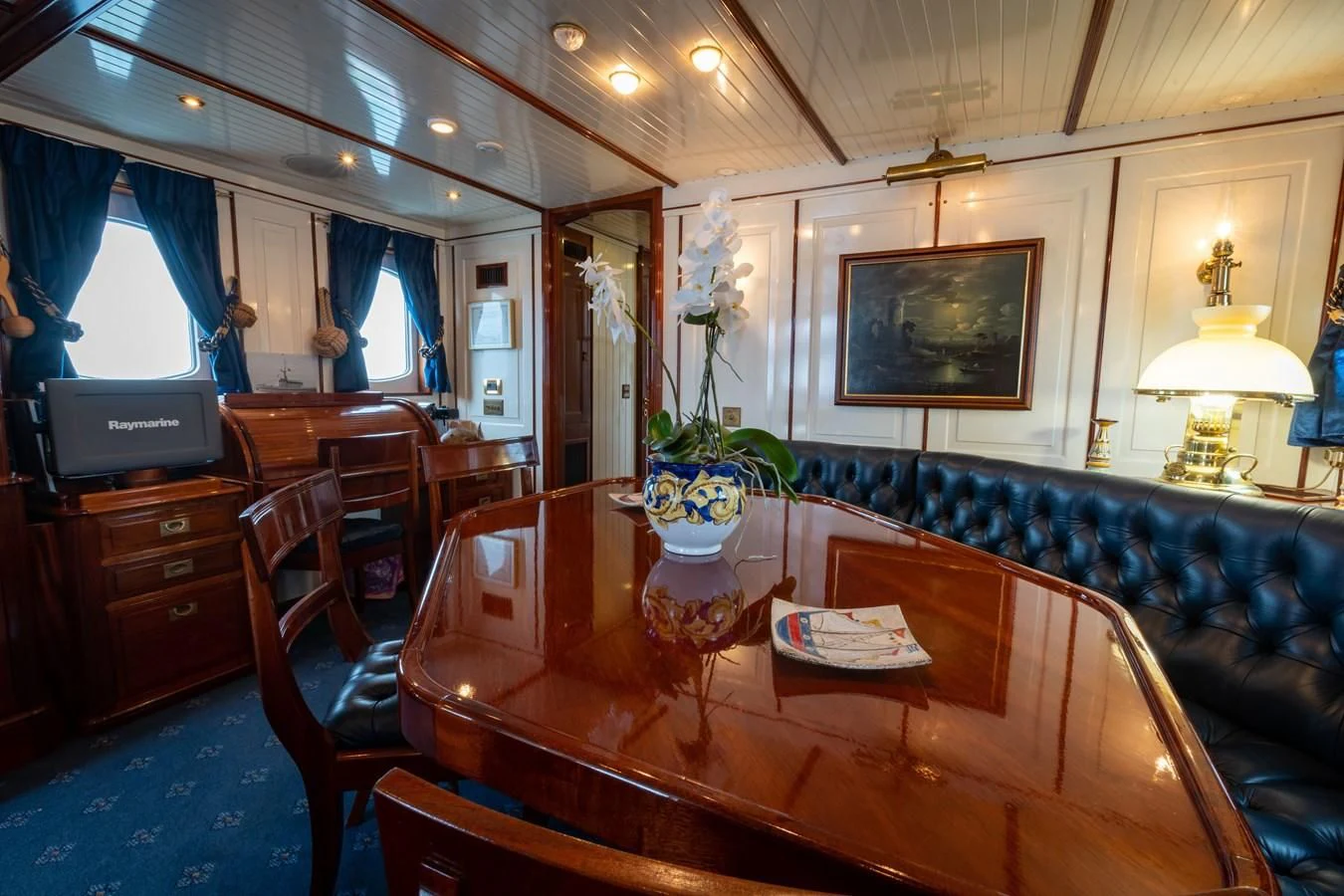 a living room with a leather couch aboard FREDRIKSTAD Yacht for Sale