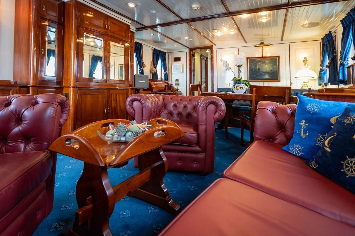 a living room with a couch and a table aboard FREDRIKSTAD Yacht for Sale