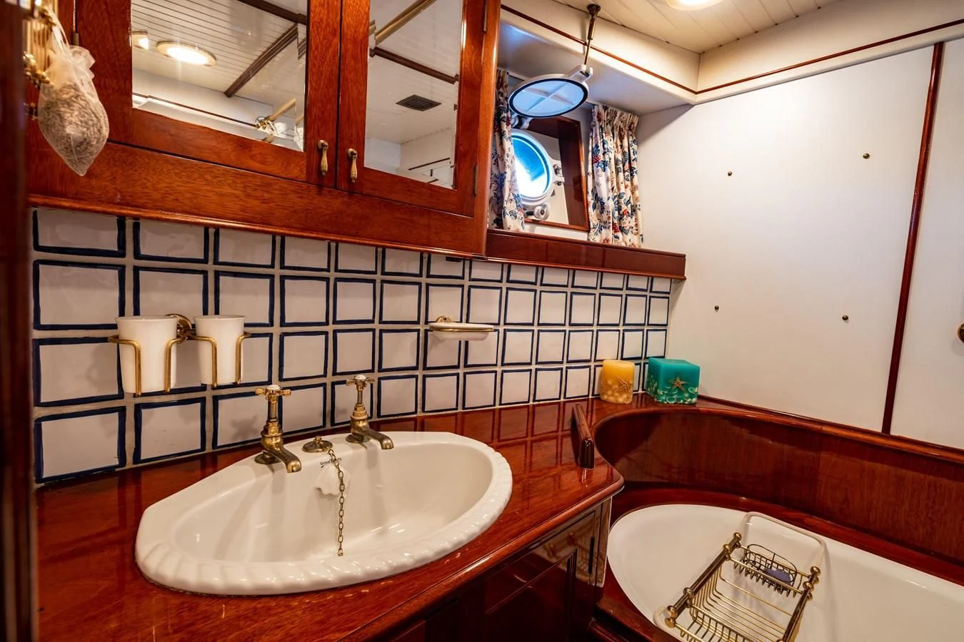 a bathroom with a sink and a mirror aboard FREDRIKSTAD Yacht for Sale