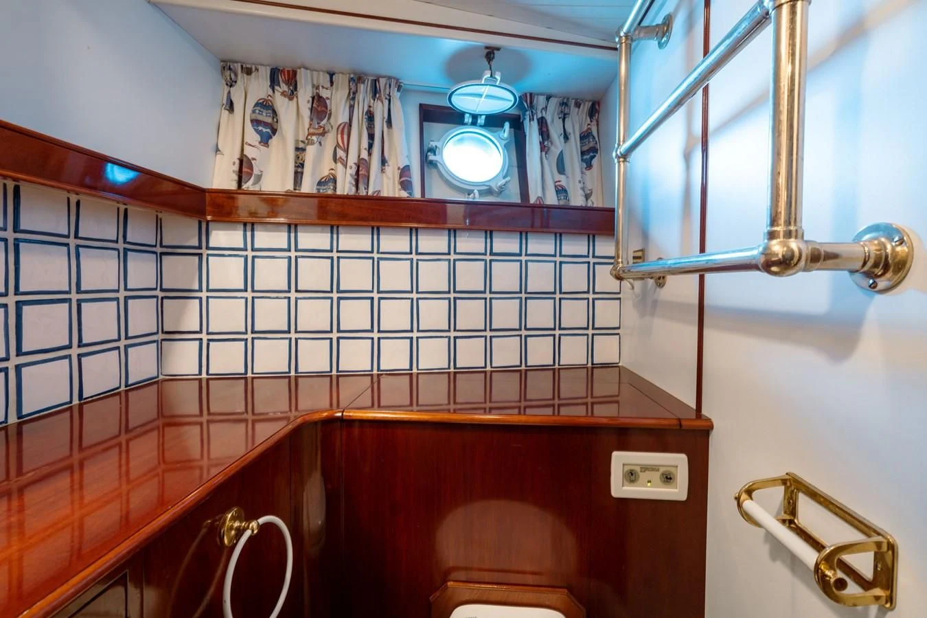 a bathroom with a tile wall aboard FREDRIKSTAD Yacht for Sale