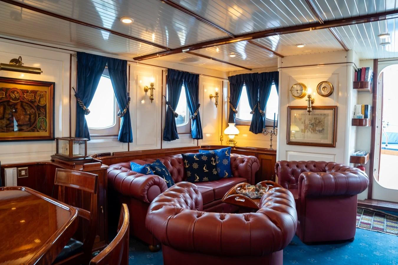 a living room with a blue carpet aboard FREDRIKSTAD Yacht for Sale