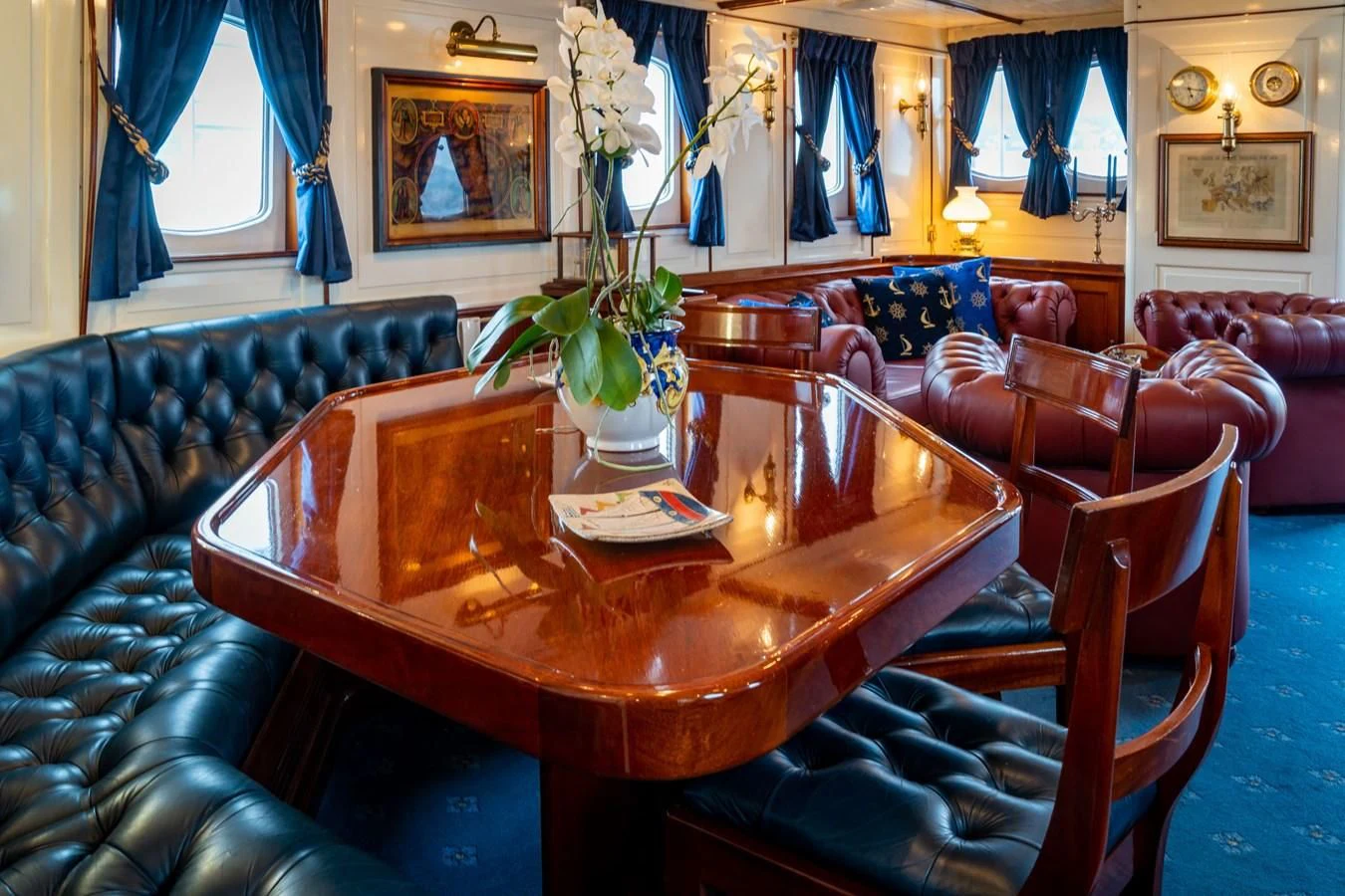 a table with chairs around it aboard FREDRIKSTAD Yacht for Sale